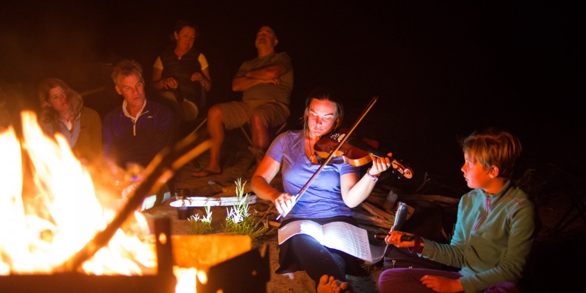 plying violin around camp fire