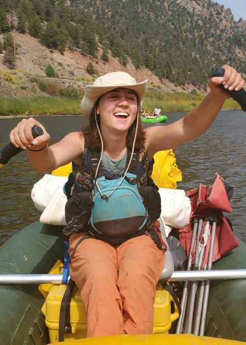 girl holding oars on river raft