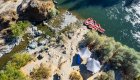 Birds eye view of a camping set up on a white sand beach next to a tributary running into the Rogue River in Oregon