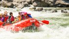 Red raft full of paddlers on the Salmon River Canyons in Idaho