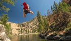 A person cliff jumping into the Middle Fork Salmon River on a sunny summer day