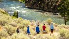 Salmon River hiking group walking along the river on a sunny summer day