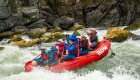 red paddle raft on the snake river in idaho going through a  rapid