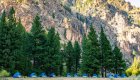 blue tents in front of wilderness area along the salmon river