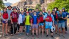 Group of whitewater rafters stop for a photo in front of Deschutes river before their adventure