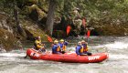 whitewater rafting group holding their paddles up on the Lochsa river in Idaho